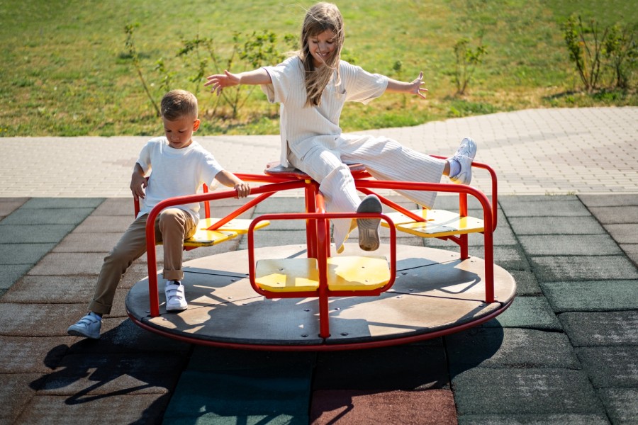 a girl and boy on a merry go round
